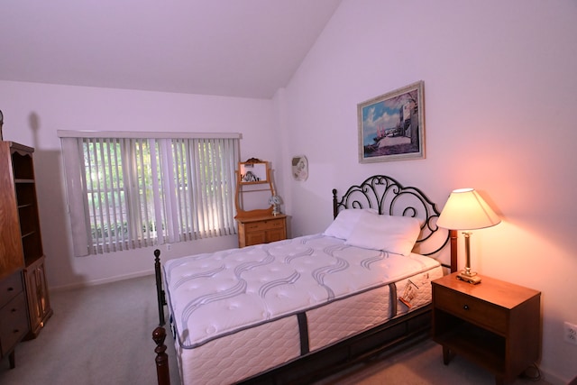 carpeted bedroom with lofted ceiling