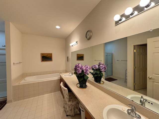 bathroom featuring plus walk in shower, vanity, tile patterned floors, and lofted ceiling