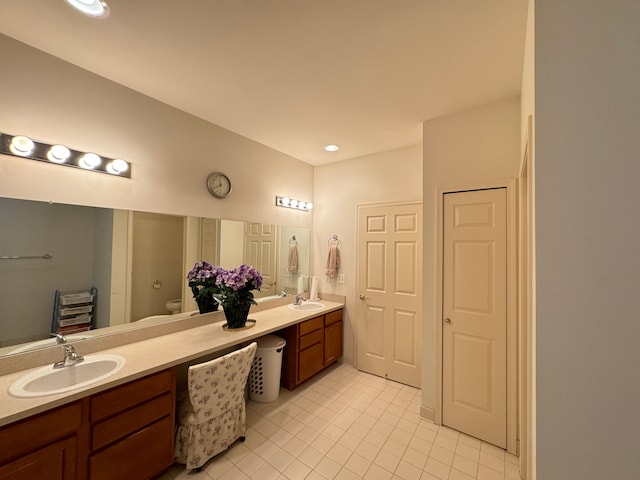 bathroom with tile patterned floors, vanity, and toilet