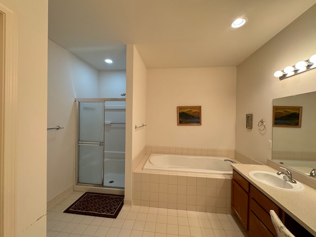 bathroom featuring plus walk in shower, tile patterned flooring, and vanity