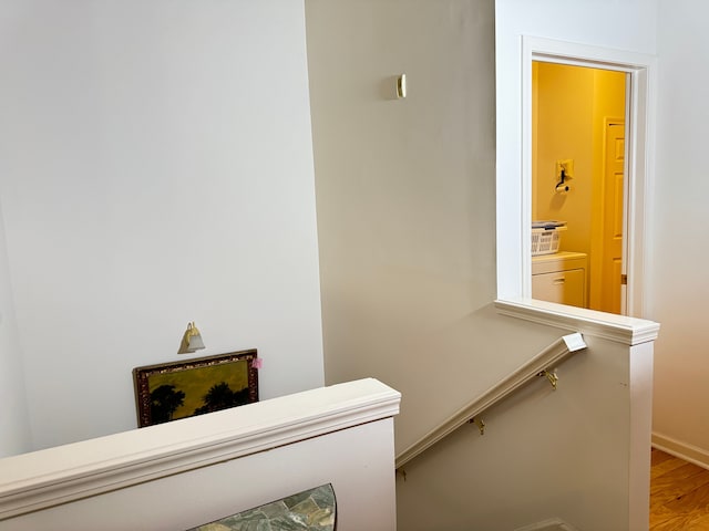 stairway with hardwood / wood-style floors