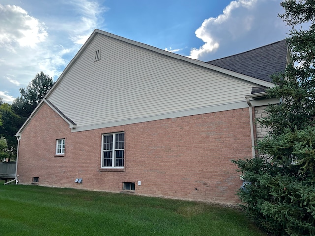 view of home's exterior with a yard