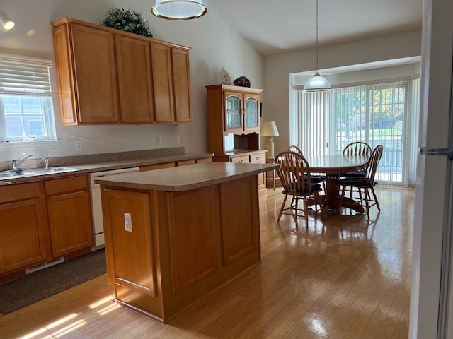 kitchen with dishwasher, a center island, a wealth of natural light, and sink