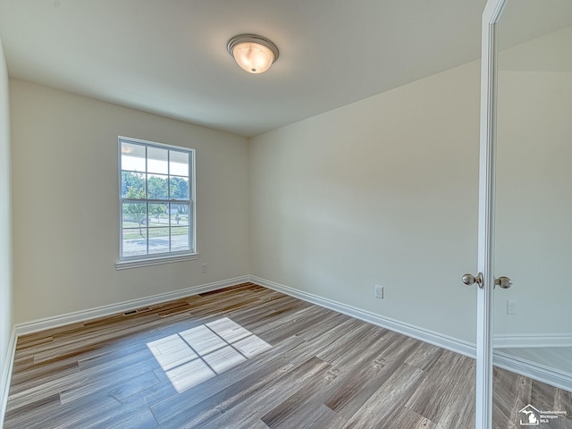 unfurnished room featuring light wood-type flooring