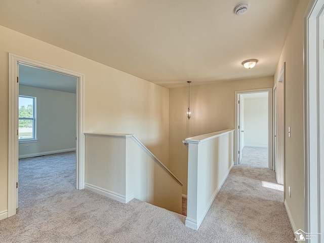 corridor with light colored carpet