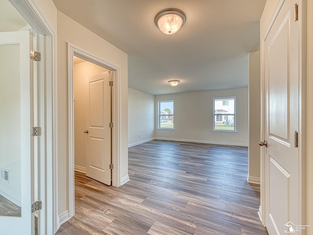 hall with hardwood / wood-style floors