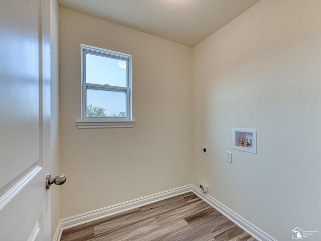 laundry area with hookup for an electric dryer, light wood-type flooring, and hookup for a washing machine