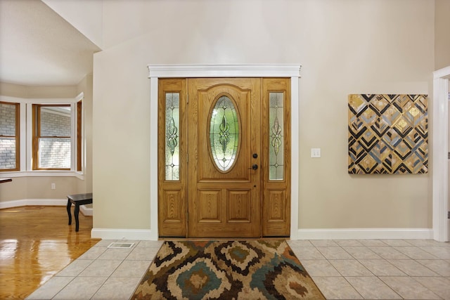 entryway featuring baseboards and light tile patterned floors