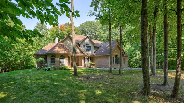 view of front facade with crawl space, brick siding, a chimney, and a front lawn