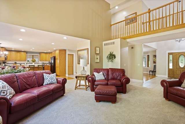 living room featuring light tile patterned floors, recessed lighting, visible vents, an inviting chandelier, and light carpet