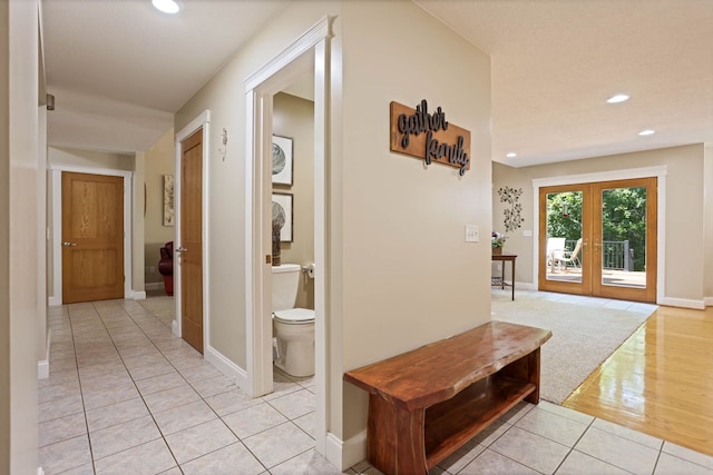 hallway with recessed lighting, french doors, baseboards, and light tile patterned floors