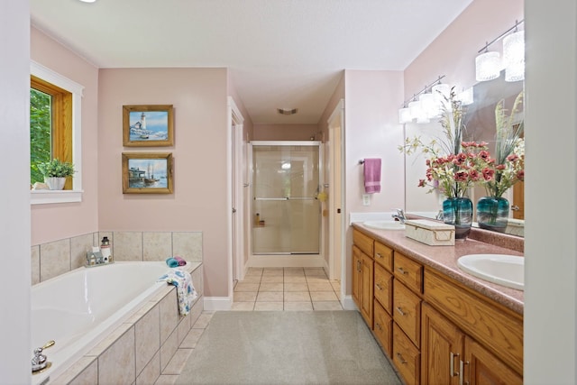 full bath with double vanity, a stall shower, a sink, a bath, and tile patterned floors