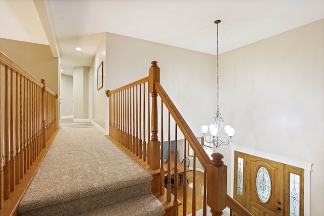 staircase featuring a chandelier, recessed lighting, a towering ceiling, and baseboards