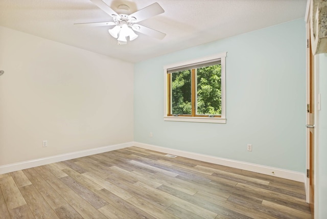 unfurnished room featuring baseboards, ceiling fan, and light wood finished floors