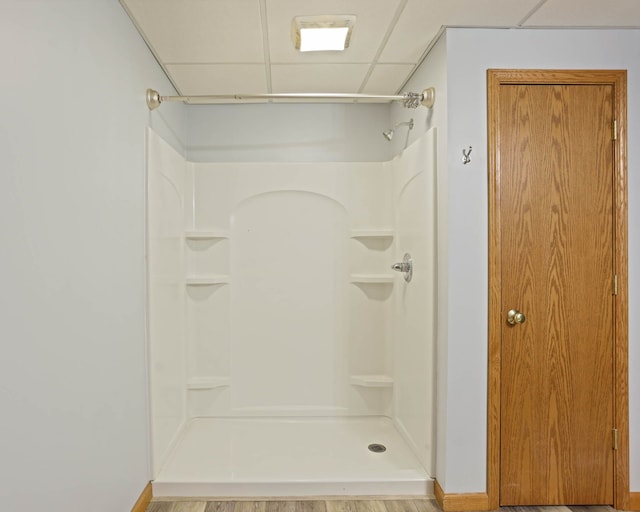 full bathroom featuring walk in shower and a drop ceiling