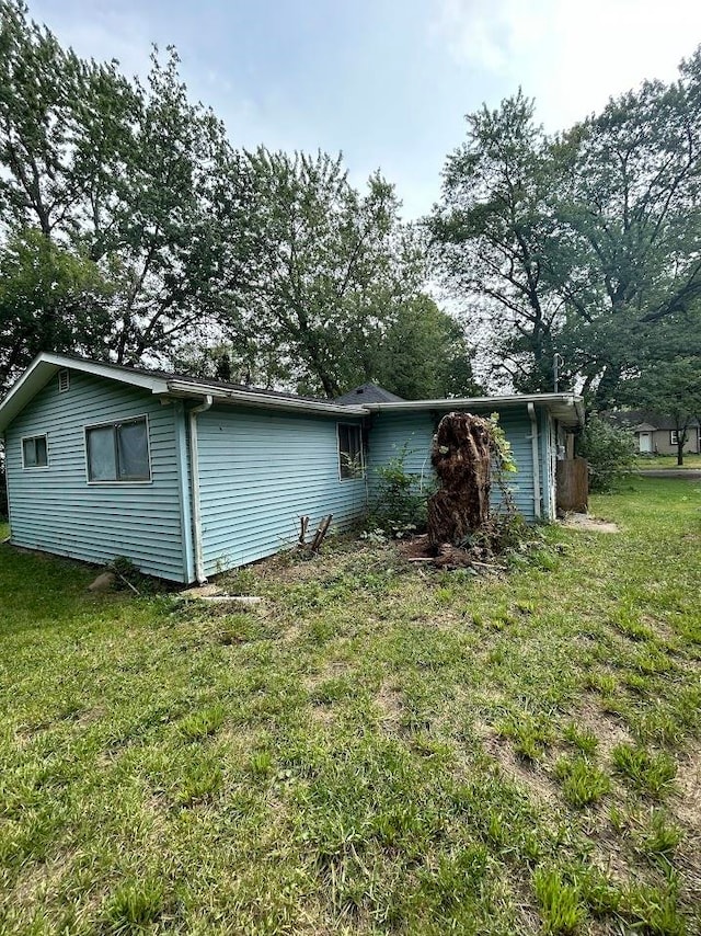 view of side of property with a yard