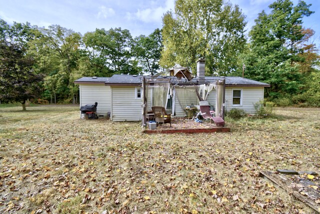 1401 S Miner Rd, Crystal, MI 48818 - back of property featuring a chimney