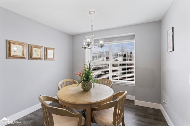 dining room featuring dark wood-type flooring and a chandelier