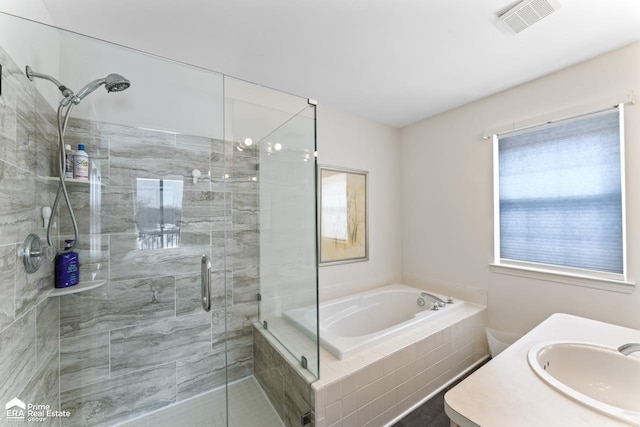 bathroom featuring vanity and shower with separate bathtub