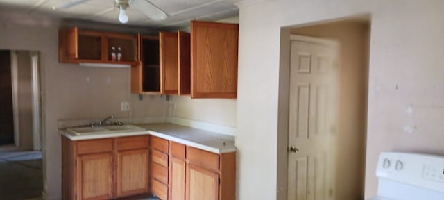 kitchen featuring ceiling fan and sink