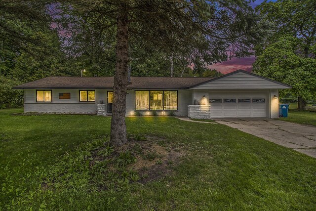 1722 N Benson Rd, Fountain, MI 49410 - view of front facade with a garage, driveway, and a front lawn