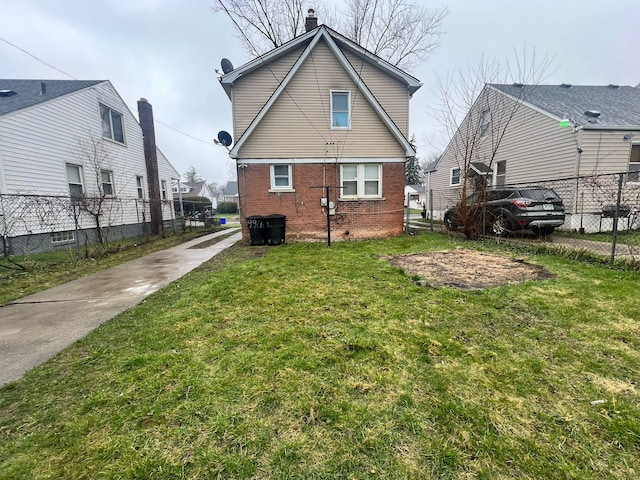 rear view of property featuring a yard