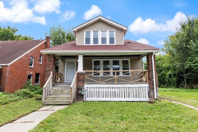 12048 Longview St, Detroit, MI 48213 - bungalow-style home featuring covered porch, a front lawn, and roof with shingles