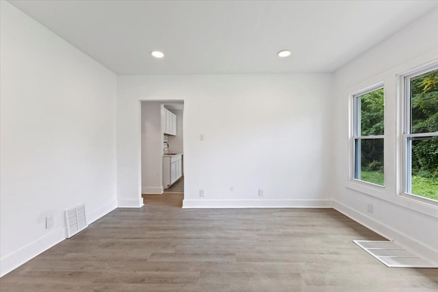 spare room featuring light hardwood / wood-style flooring