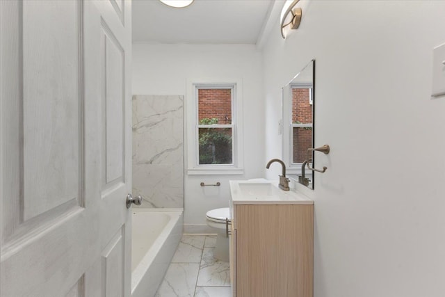 bathroom featuring a bathing tub, vanity, and toilet