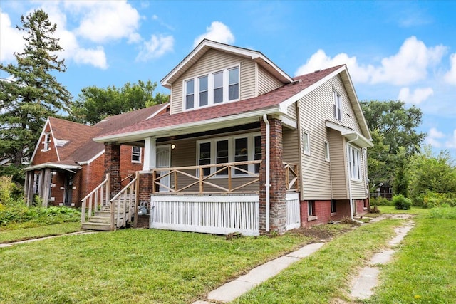 view of front facade with a front yard and a porch