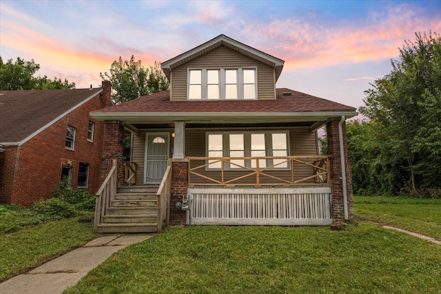 view of front of home with a yard and covered porch