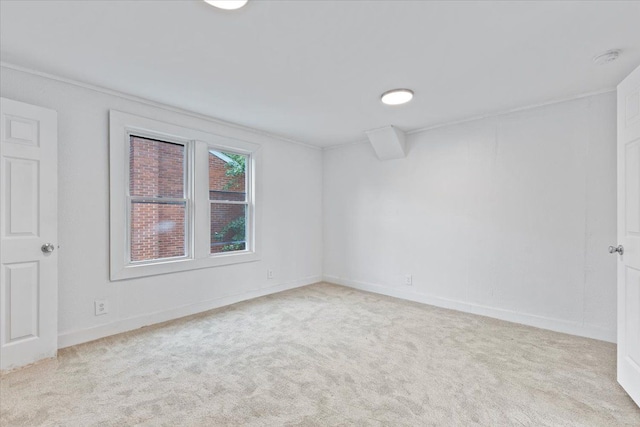 unfurnished room featuring light colored carpet