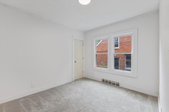 carpeted empty room with ornamental molding