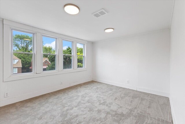 12048 Longview St, Detroit, MI 48213 - empty room with healthy amount of natural light, carpet, and baseboards