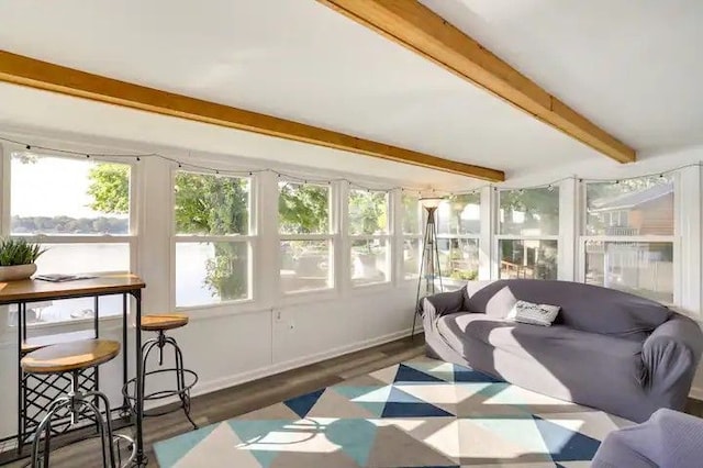 sunroom / solarium featuring beam ceiling