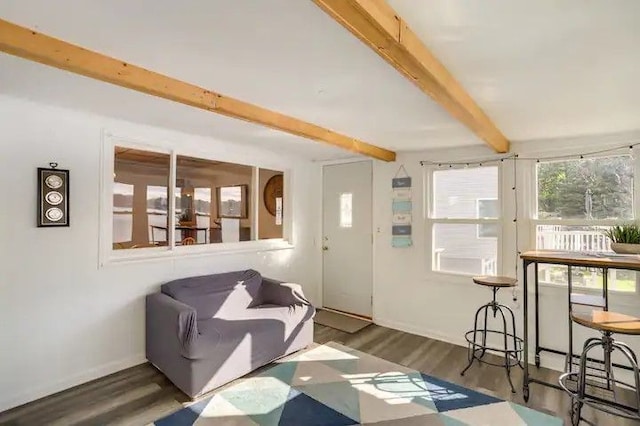 living room featuring beamed ceiling and dark hardwood / wood-style flooring