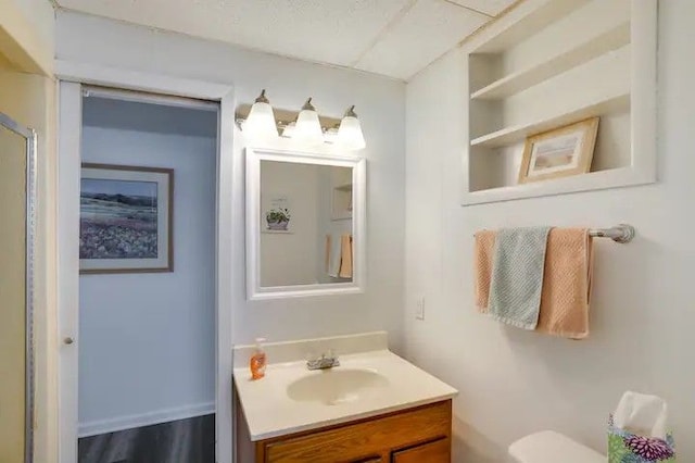 bathroom with hardwood / wood-style flooring, vanity, and toilet