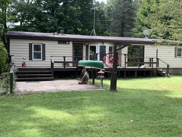 15070 Rapids Dr, Hersey, MI 49639 - rear view of house featuring a wooden deck, a patio area, and a lawn