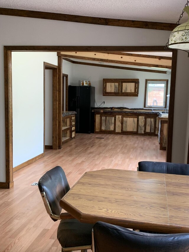 15070 Rapids Dr, Hersey, MI 49639 - living area featuring beamed ceiling, light wood-style flooring, and a textured ceiling