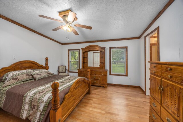 15070 Rapids Dr, Hersey, MI 49639 - bedroom featuring light wood-type flooring, a textured ceiling, a ceiling fan, crown molding, and baseboards