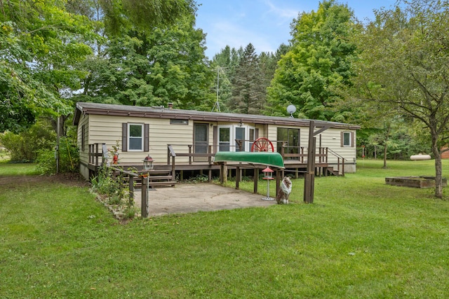 back of property with a patio area, a deck, and a yard