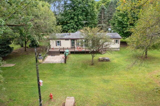 15070 Rapids Dr, Hersey, MI 49639 - back of house featuring a wooden deck and a yard