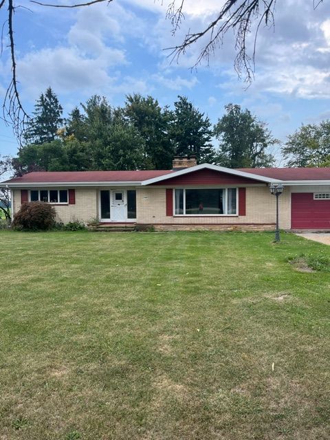 single story home with a front yard and a garage