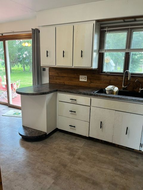 kitchen with white cabinetry and sink