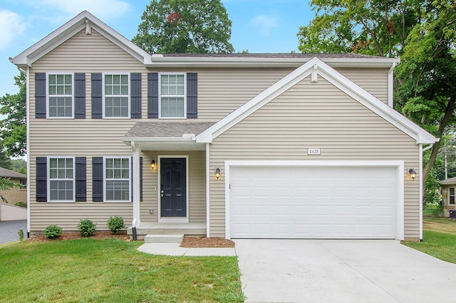 view of front of house featuring a garage and a front yard