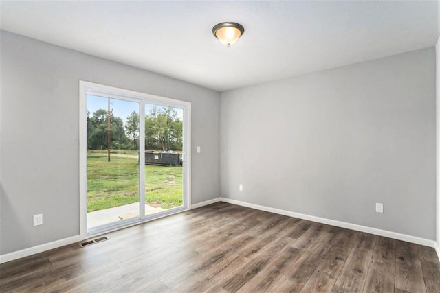 empty room with dark hardwood / wood-style floors