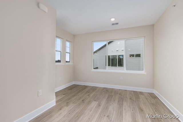 empty room with light hardwood / wood-style flooring