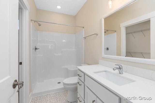 bathroom with vanity, toilet, and walk in shower