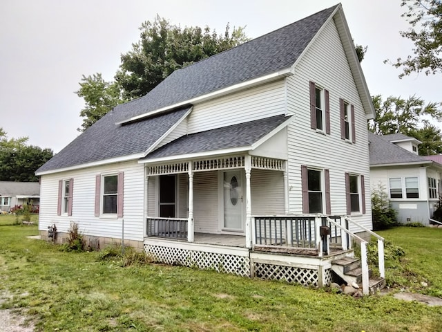 view of front of home with covered porch and a front lawn