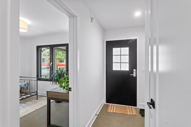 foyer entrance with dark colored carpet